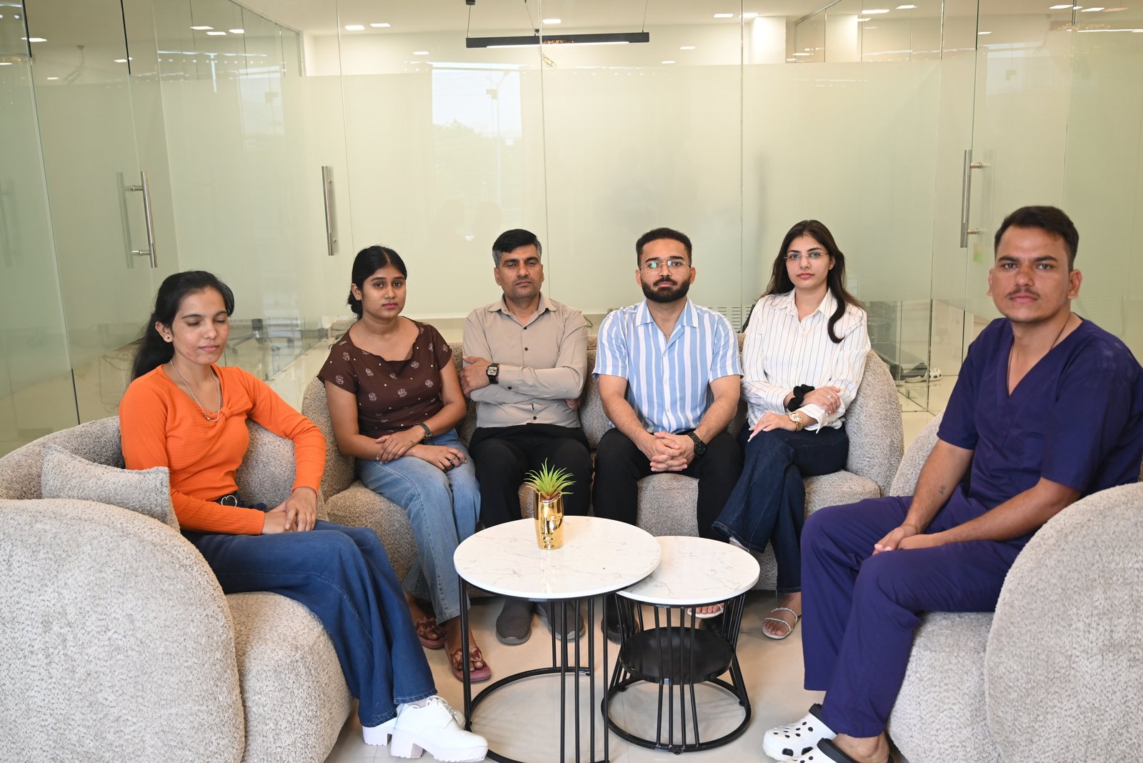 The K7 Homecare team seated together in the reception area of the K7 Homecare centre